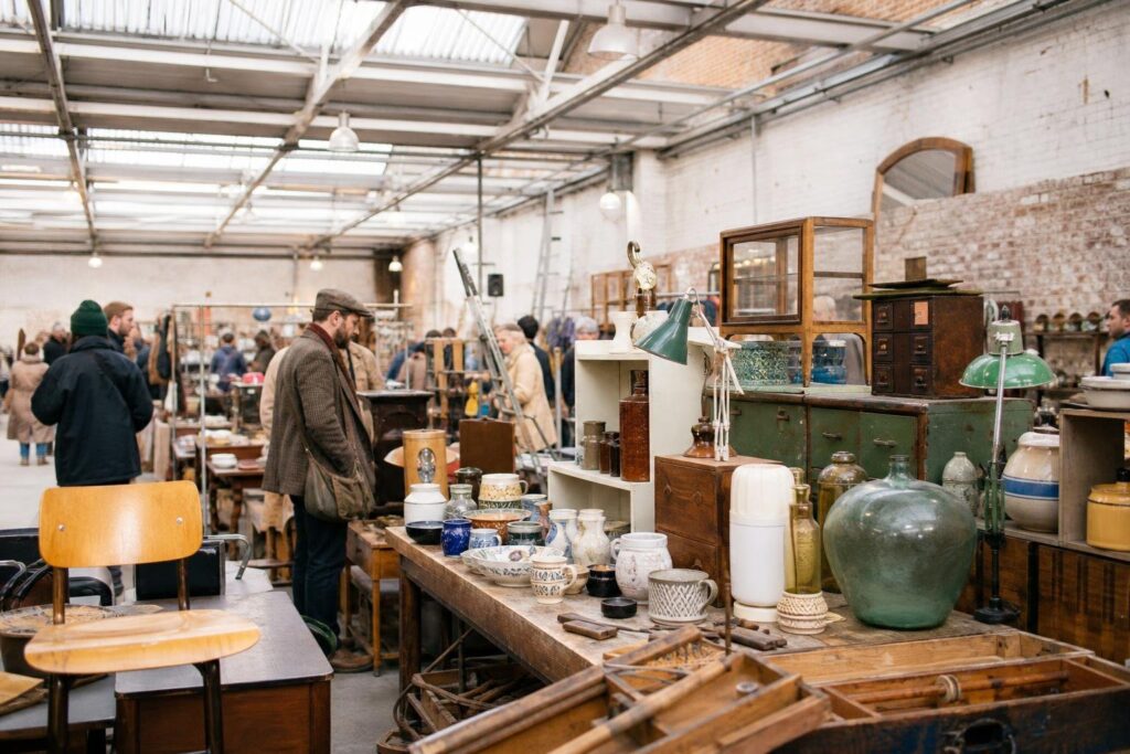 shoppers browsing antique and vintage market stalls at Peckham Salvage Yard in London