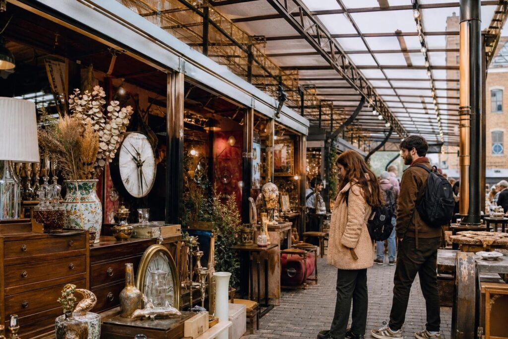 shoppers browsing antique and vintage market stalls at Camden Market in London
