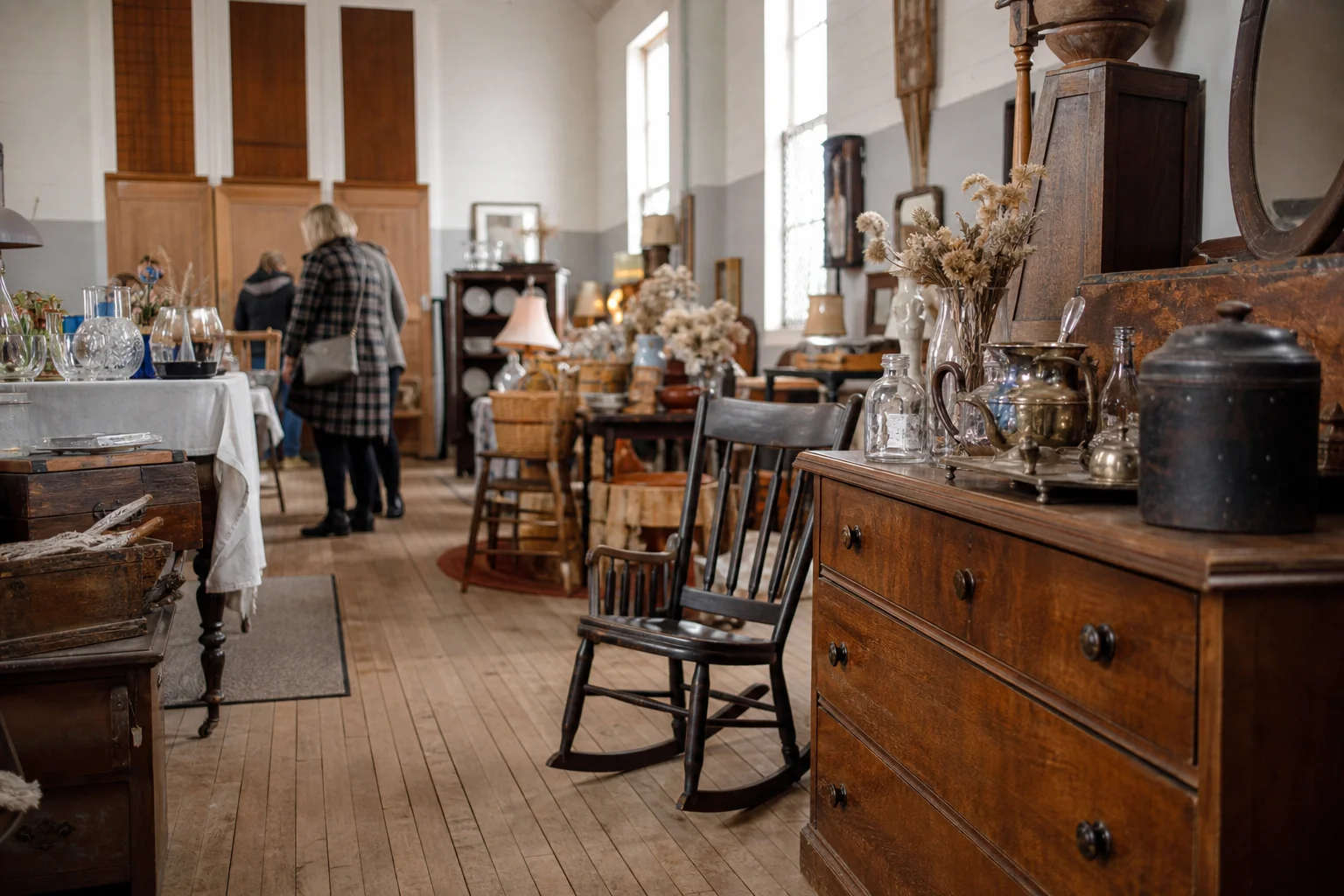 shoppers browsing antique and vintage market stalls at The Lexington Antique Show in Kentucky