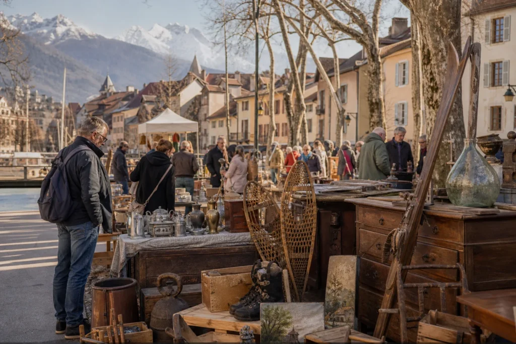 shoppers browsing antique and vintage market stalls at Annecy Flea Market in France