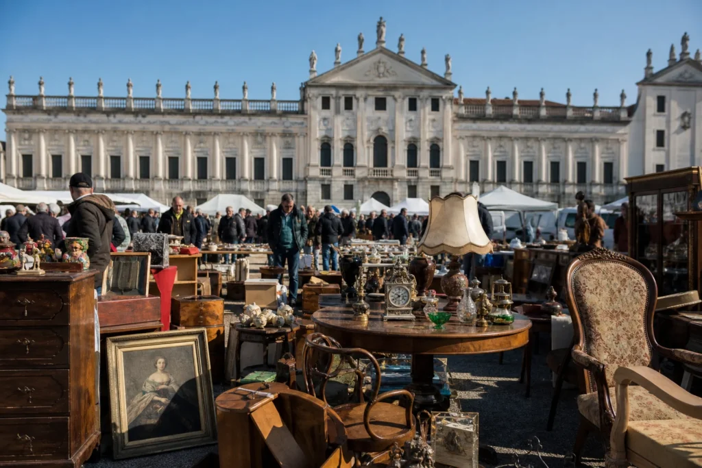 shoppers browsing antique and vintage market stalls at Antiquariato a Piazzola sul Brenta in Italy