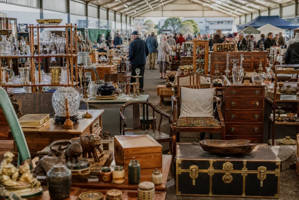shoppers browsing antique and vintage market stalls at Antique and Collectors Fair in New Zealand