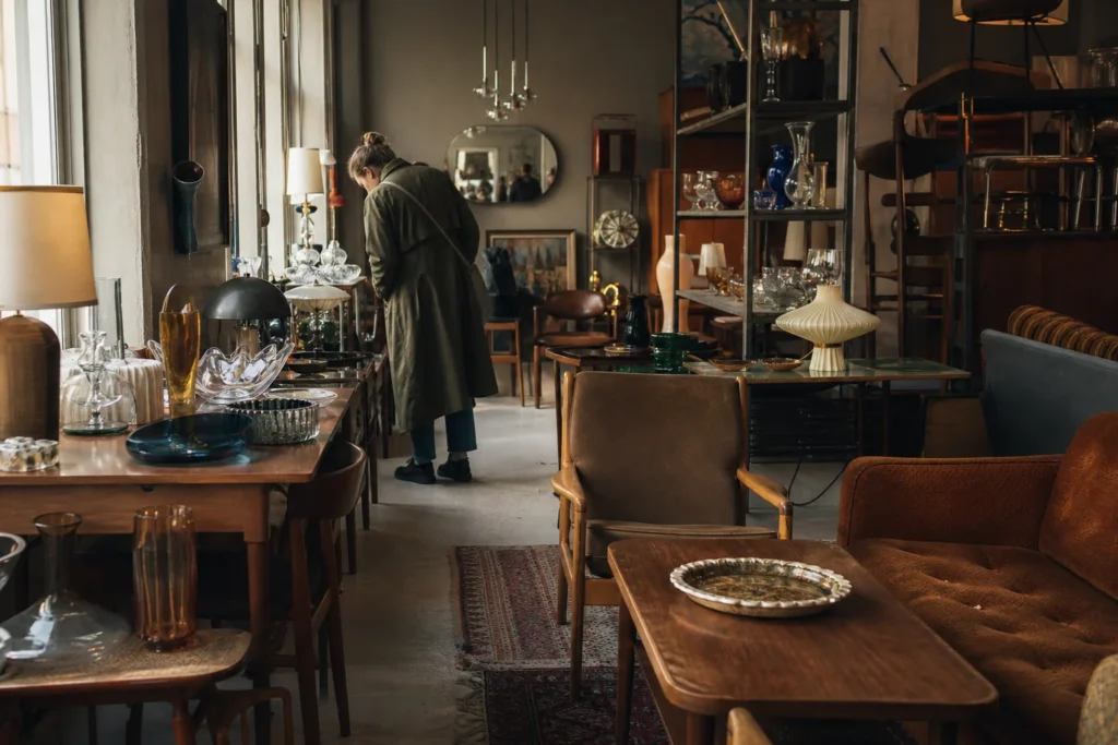 shoppers browsing antique and vintage market stalls at Antique shops in Södermalm in Sweden