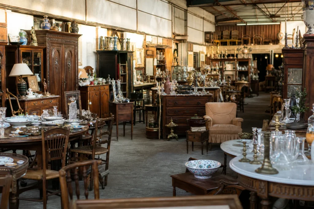 shoppers browsing antique and vintage market stalls at Antiquité Hervé Ritter in France