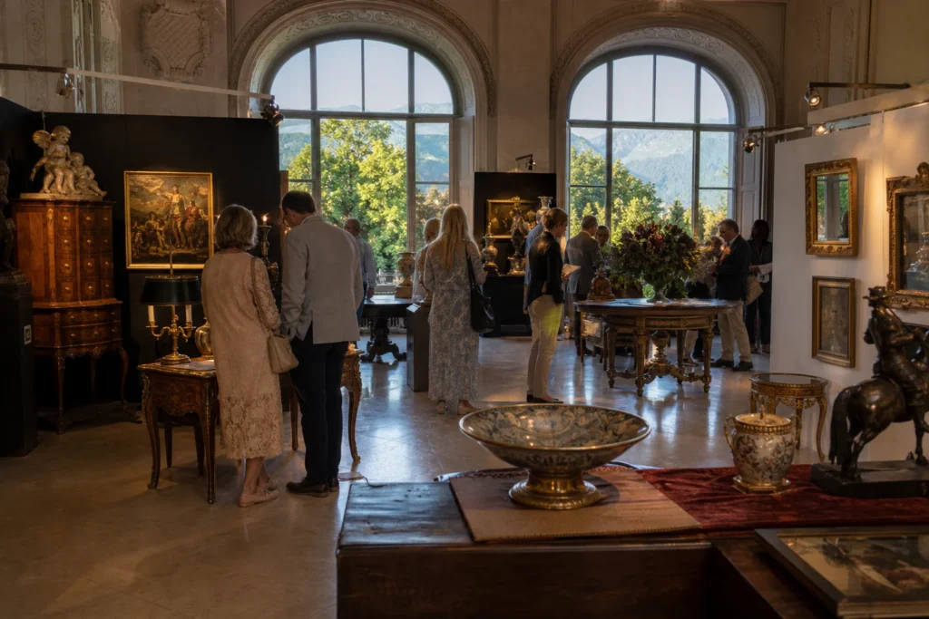 shoppers browsing antique and vintage market stalls at Art & Antique Salzburg in Austria