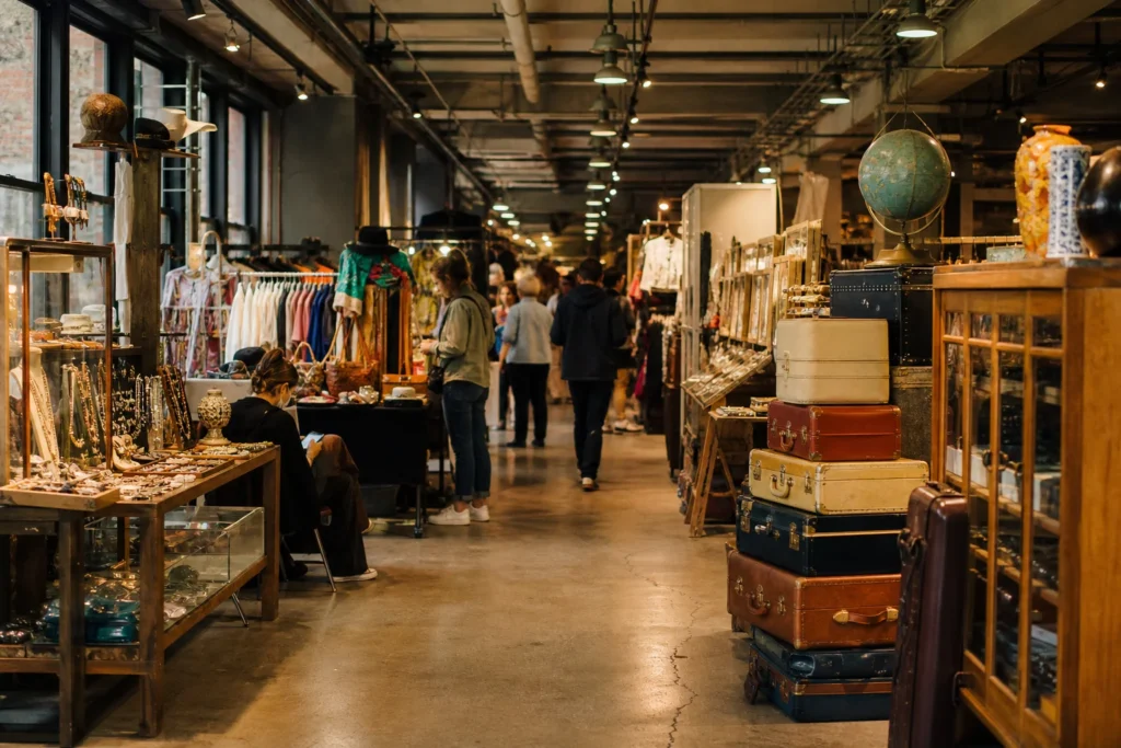 shoppers browsing antique and vintage market stalls at Artists & Fleas Chelsea in New York City, New York State