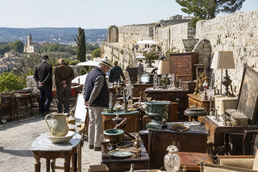 shoppers browsing antique and vintage market stalls at Brocante de Villeneuve-lès-Avignon in Provence