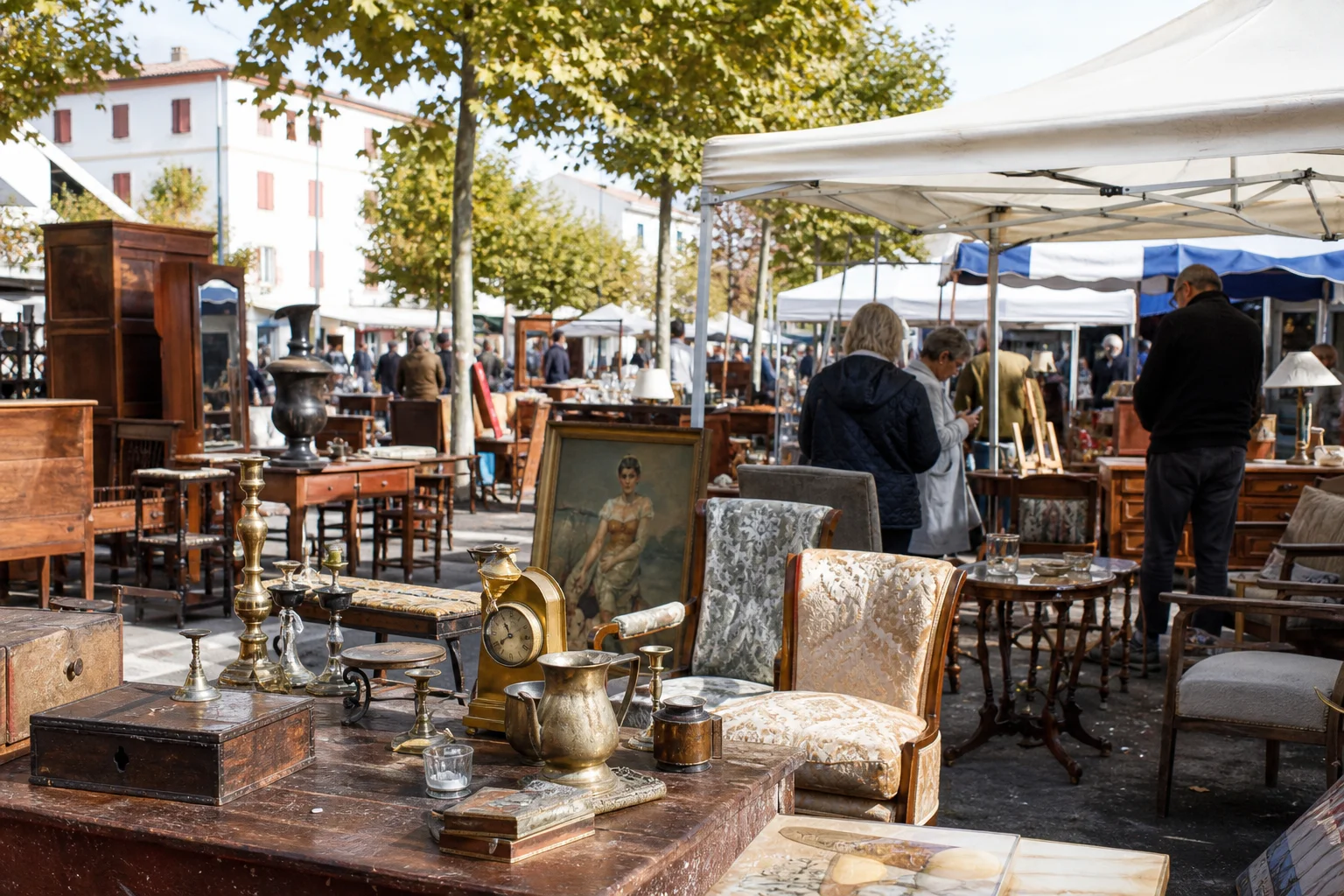 shoppers browsing antique and vintage market stalls at Brocante des Cinq-Cantons in France