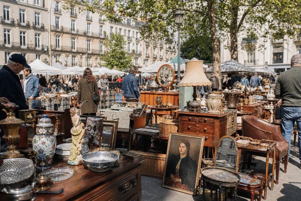 shoppers browsing antique and vintage market stalls at Brocante Place Viarme in France