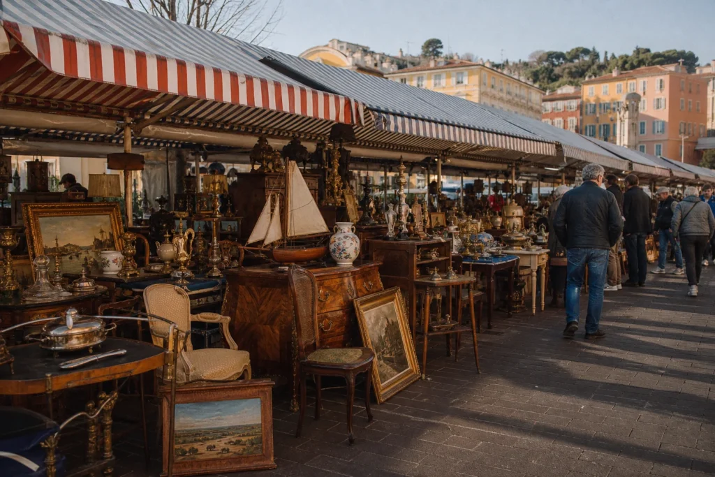 shoppers browsing antique and vintage market stalls at Brocante Saleya in Provence