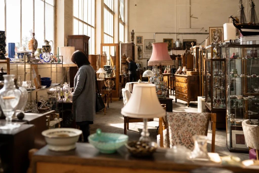 shoppers browsing antique and vintage market stalls at Cambrian House Emporium in United Kingdom