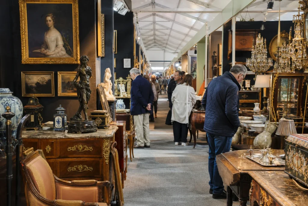 shoppers browsing antique and vintage market stalls at Chelsea Antiques & Fine Art Fair in London