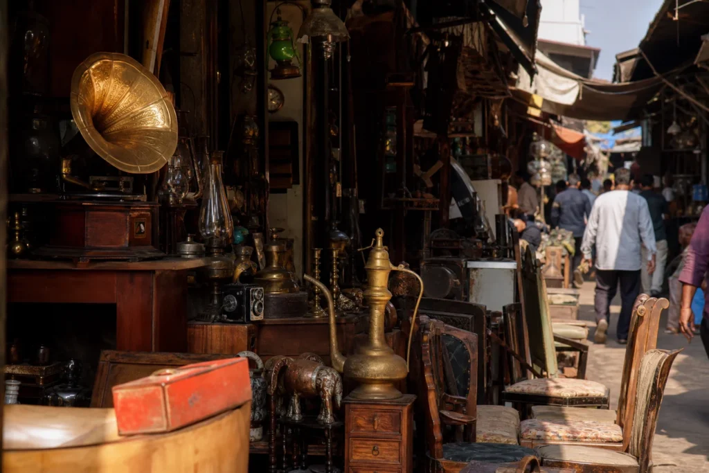 shoppers browsing antique and vintage market stalls at Chor Bazaar in India