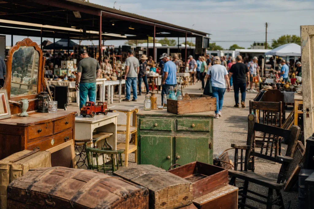 shoppers browsing antique and vintage market stalls at Cole’s Flea Market in Texas
