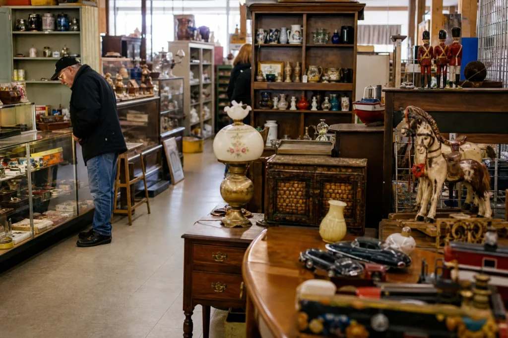 shoppers browsing antique and vintage market stalls at Collins Bay Flea Market in Canada, Ontario
