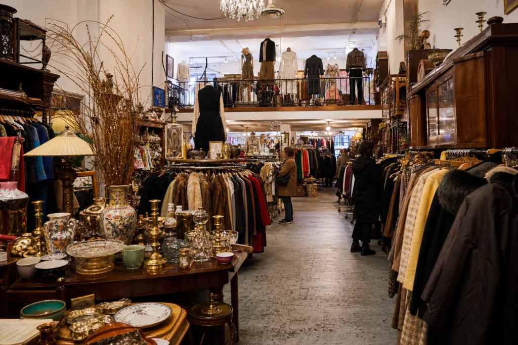 shoppers browsing antique and vintage market stalls at Cure Thrift Shop in New York City, New York State