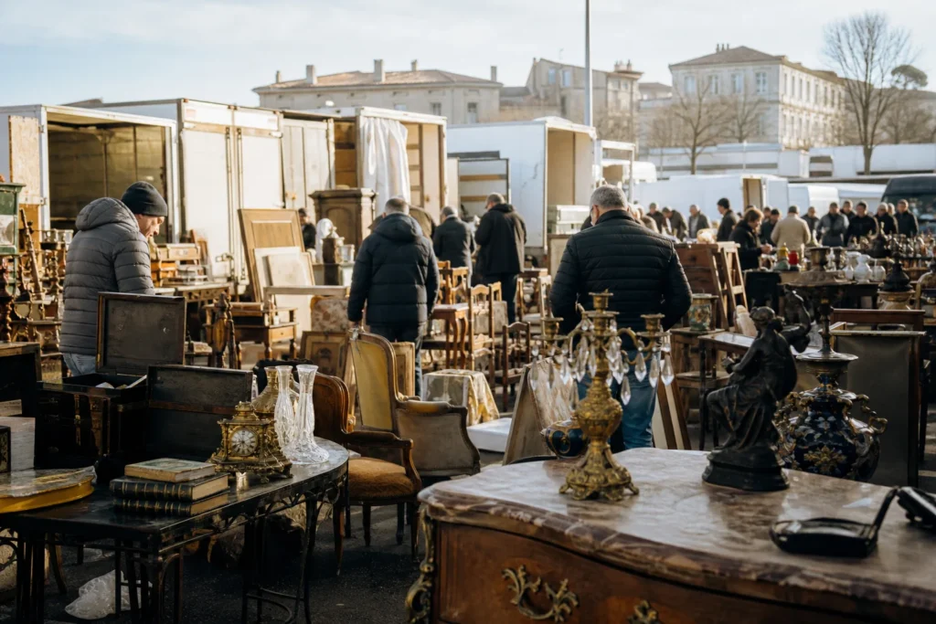 shoppers browsing antique and vintage market stalls at Déballage Marchand de Béziers in France