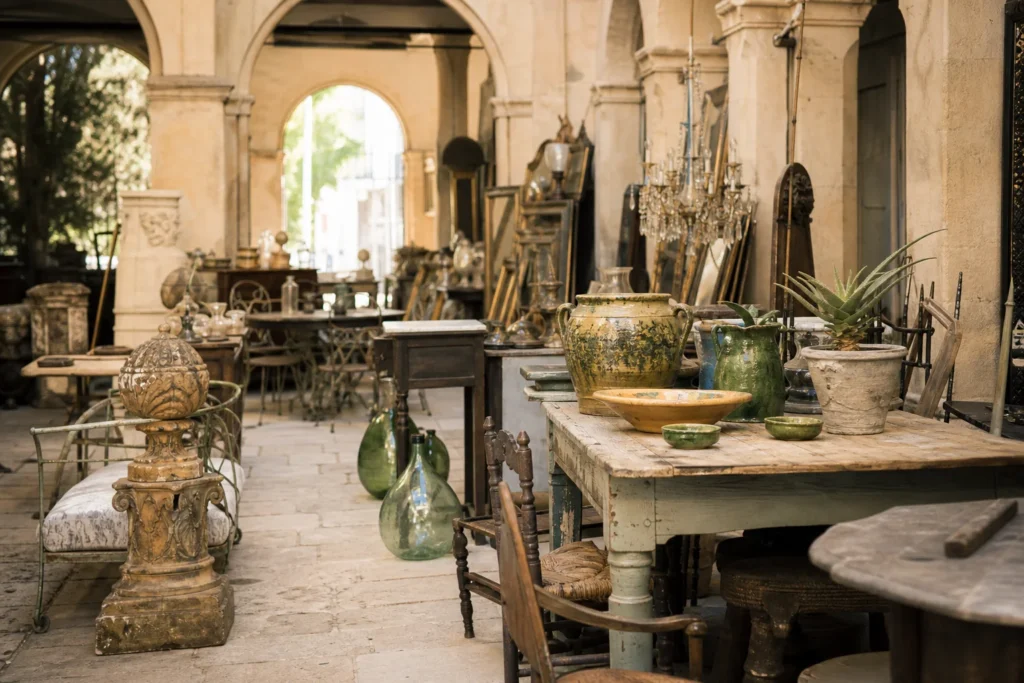 shoppers browsing antique and vintage market stalls at Decorative Collective in Place Charles David, 30400 Villeneuve-lès-Avignon, France
