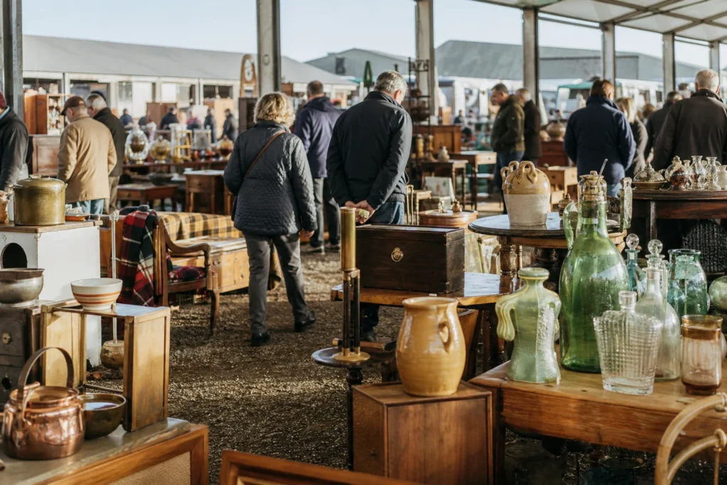 shoppers browsing antique and vintage market stalls at Detling Showground Antiques & Vintage Fair in United Kingdom