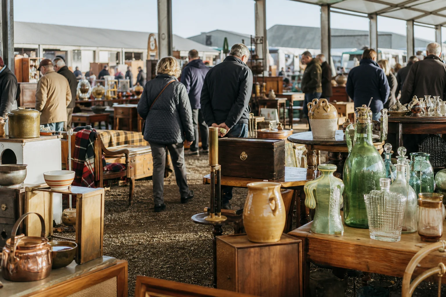 shoppers browsing antique and vintage market stalls at Detling Showground Antiques & Vintage Fair in United Kingdom