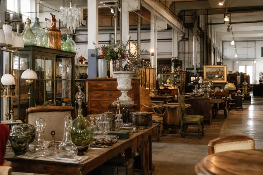 shoppers browsing antique and vintage market stalls at Die Glasfabrik in Austria