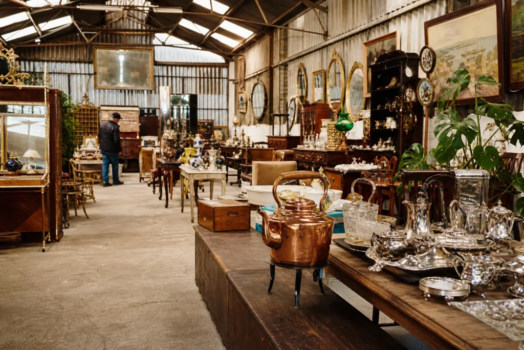 shoppers browsing antique and vintage market stalls at Drum Farm Antiques in United Kingdom