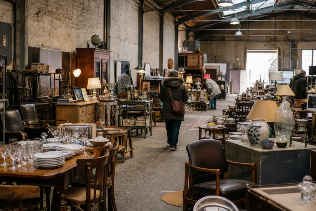 shoppers browsing antique and vintage market stalls at Dubalai Débarras in France