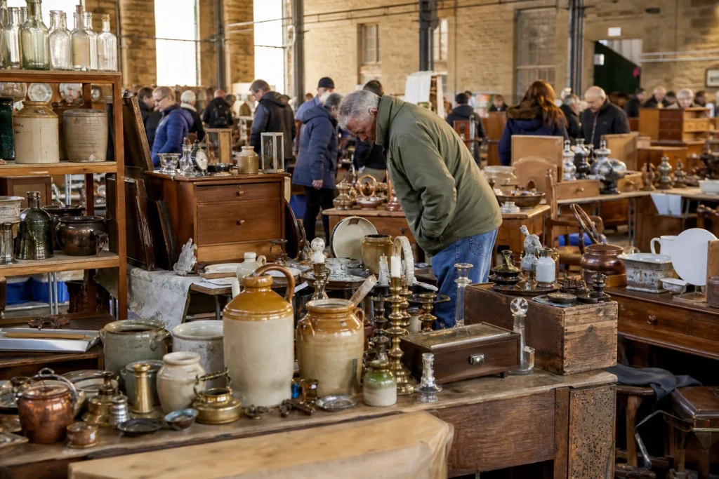 shoppers browsing antique and vintage market stalls at Elsecar Antiques and Collectables Fairs in United Kingdom