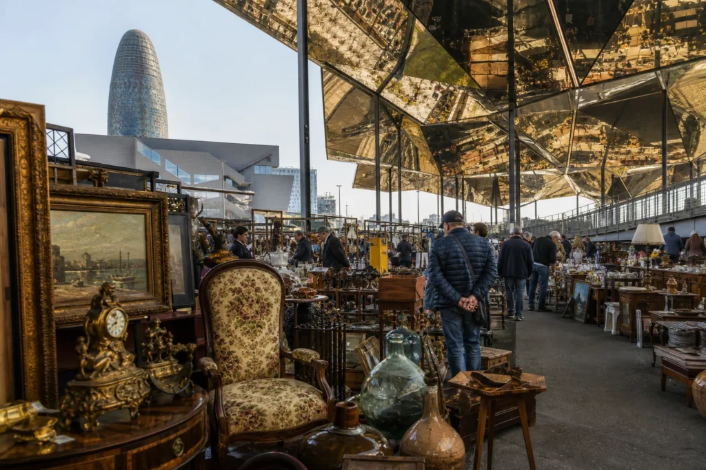 shoppers browsing antique and vintage market stalls at Encants Vells Flea Market in Spain