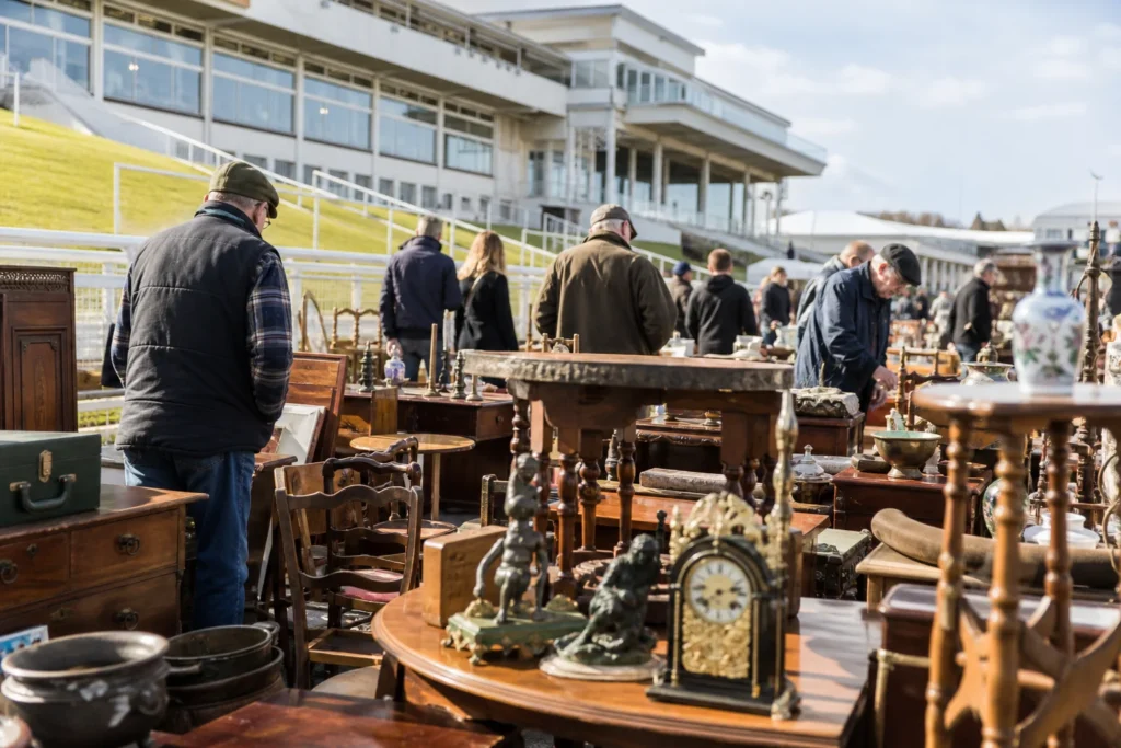 shoppers browsing antique and vintage market stalls at Epsom Racecourse Antiques and Collectables Fair in United Kingdom