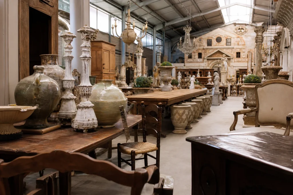 shoppers browsing antique and vintage market stalls at European Antiques Warehouse in Belgium