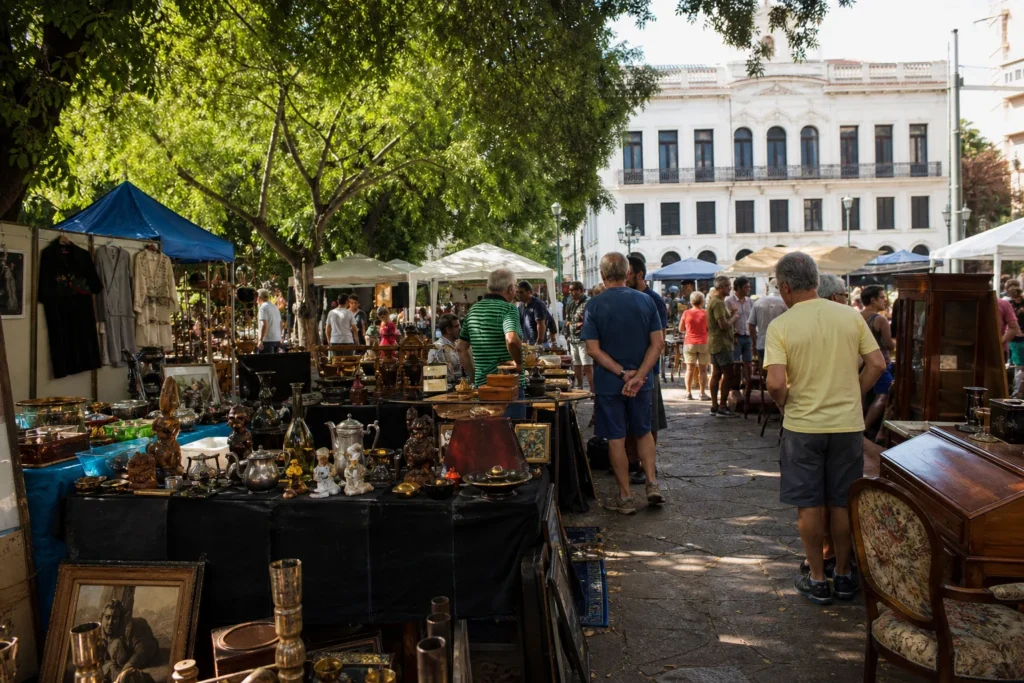 shoppers browsing antique and vintage market stalls at Feira de Antiguidades da Praça XV in Brazil