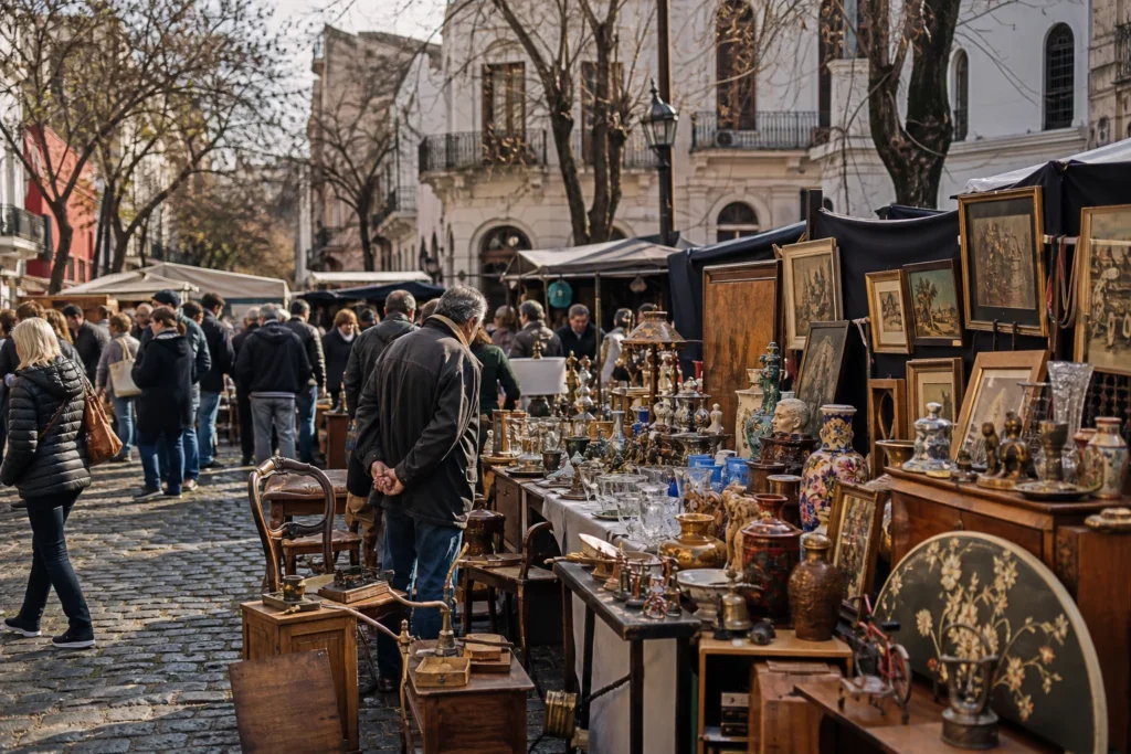 shoppers browsing antique and vintage market stalls at Feria de las Antigüedades y las Cosas Viejas de San Pedro Telmo in Argentina