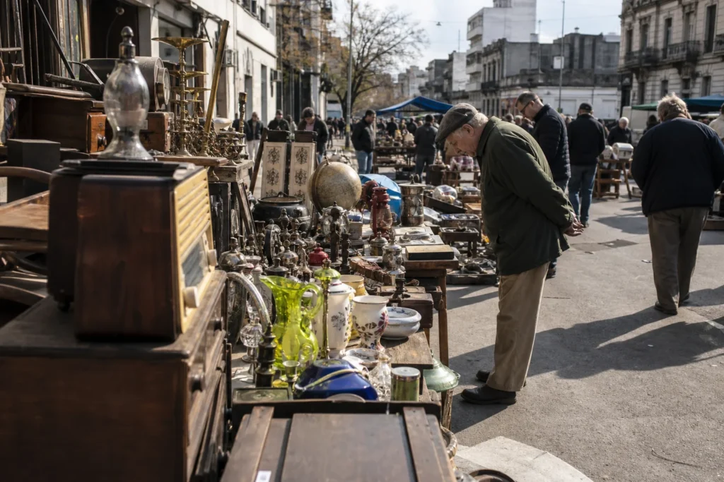 shoppers browsing antique and vintage market stalls at Feria de Tristan Narvaja in Uruguay