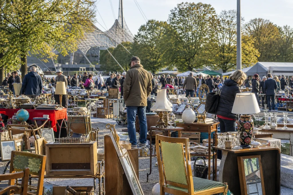 shoppers browsing antique and vintage market stalls at Flohmarkt im Olympiapark in Germany