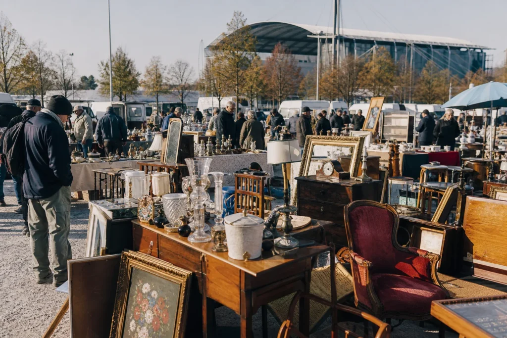 shoppers browsing antique and vintage market stalls at Flohmarkt München-Riem in Germany