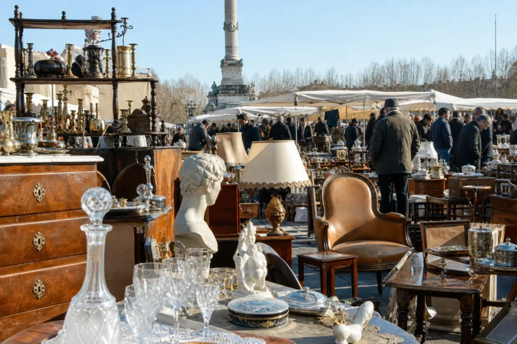 shoppers browsing antique and vintage market stalls at Foire à la Brocante des Quinconces in France