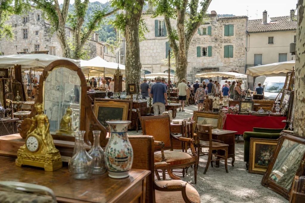 shoppers browsing antique and vintage market stalls at Foire aux Antiquités et à la Brocante de Barjac in France