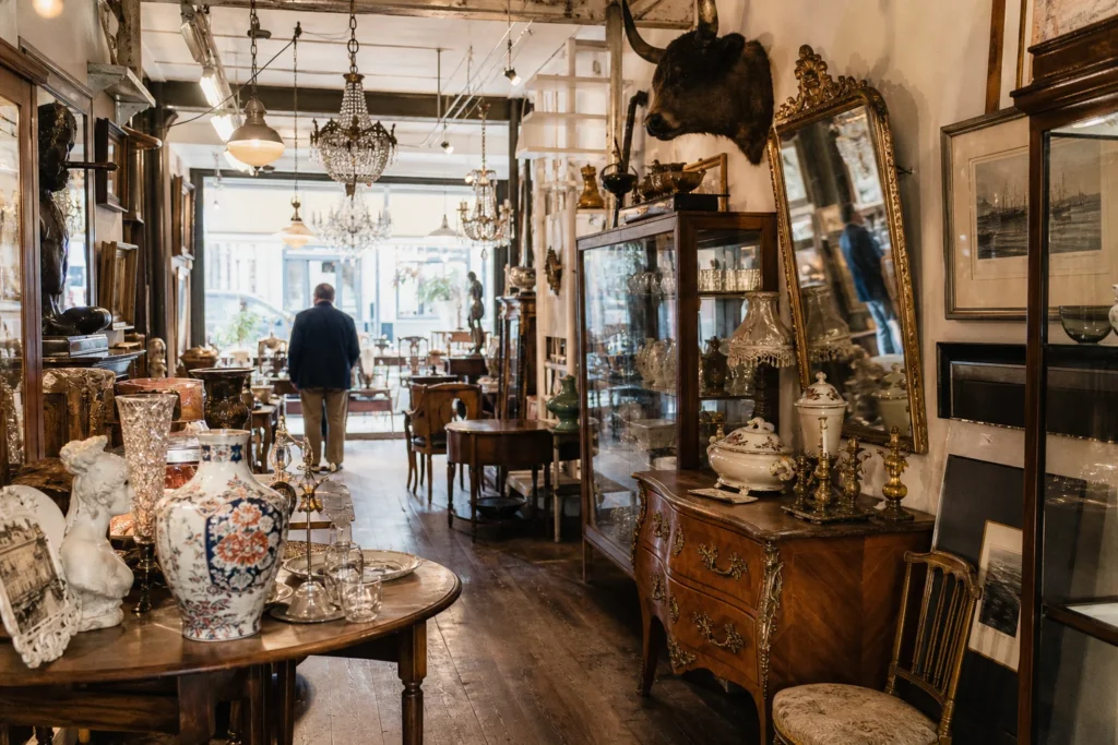 shoppers browsing antique and vintage market stalls at Galerie Des Minimes in Belgium