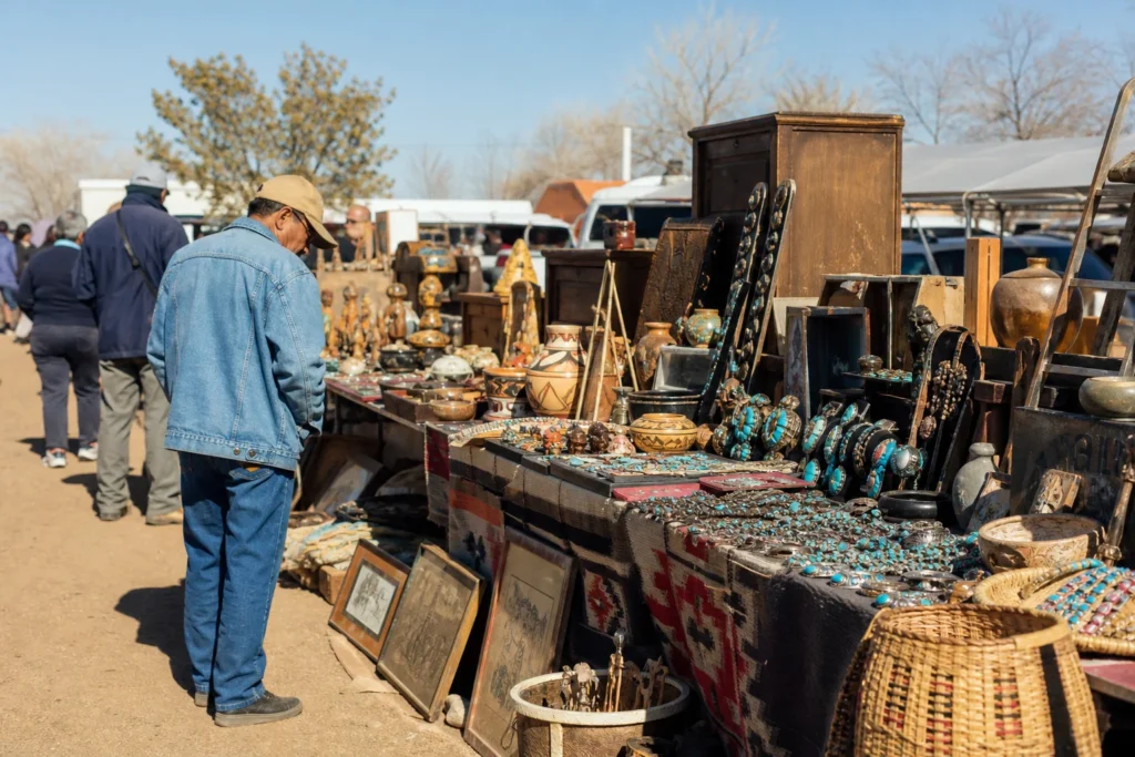 shoppers browsing antique and vintage market stalls at Gallup 9th Street Flea Market in New Mexico