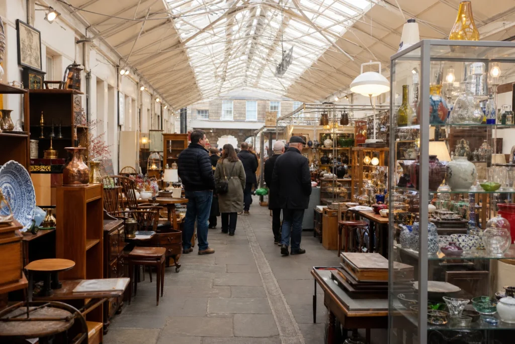 shoppers browsing antique and vintage market stalls at Greenwich Market in London