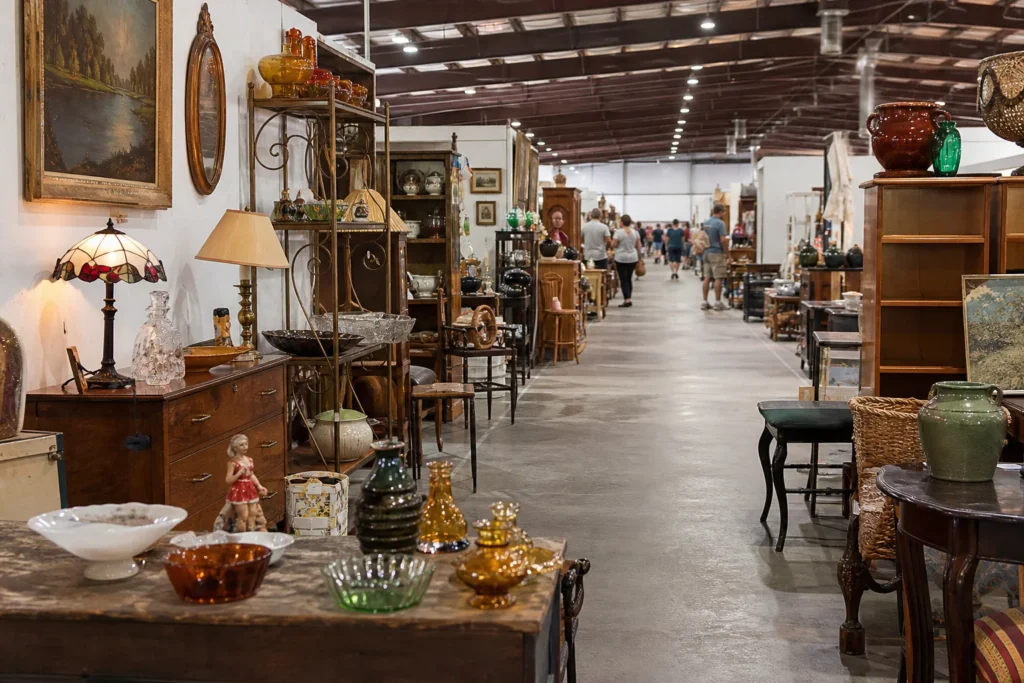 shoppers browsing antique and vintage market stalls at Greenwood Flea Market in Louisiana