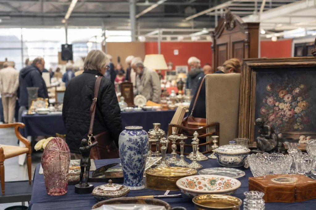 shoppers browsing antique and vintage market stalls at Helsingborgs Konst & Antikmässa in Sweden