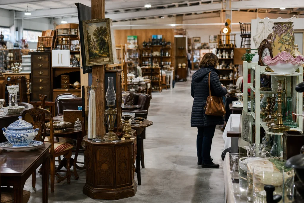 shoppers browsing antique and vintage market stalls at Heritage Antique Market in Delaware