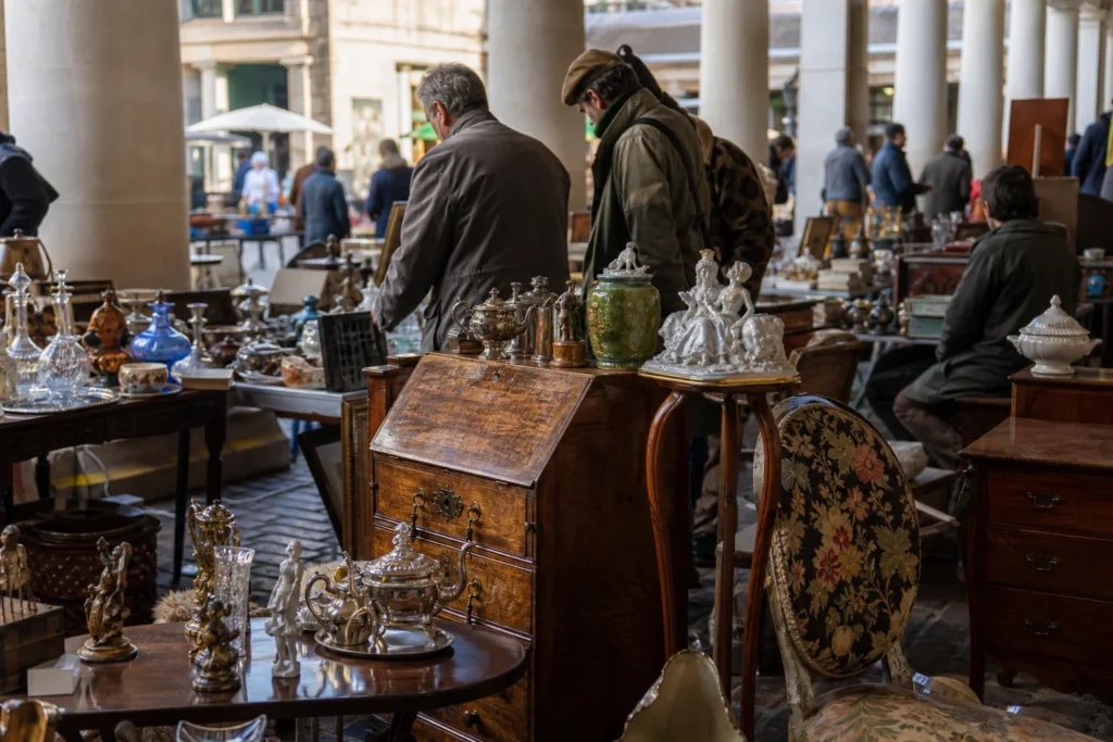shoppers browsing antique and vintage market stalls at Jubilee Market in London
