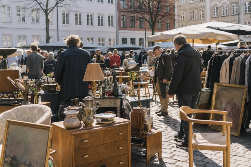 shoppers browsing antique and vintage market stalls at Københavns Loppetorv in Copenhagen