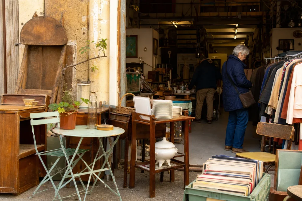 shoppers browsing antique and vintage market stalls at La Récupérette in France