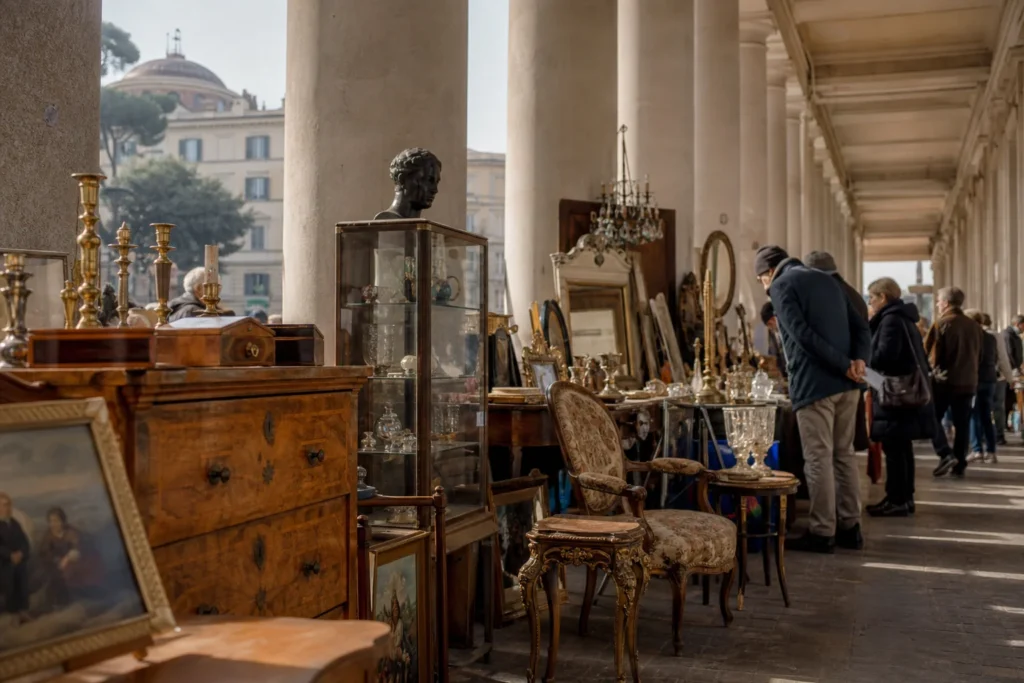 shoppers browsing antique and vintage market stalls at La Soffitta Sotto I Portici in Italy, Rome