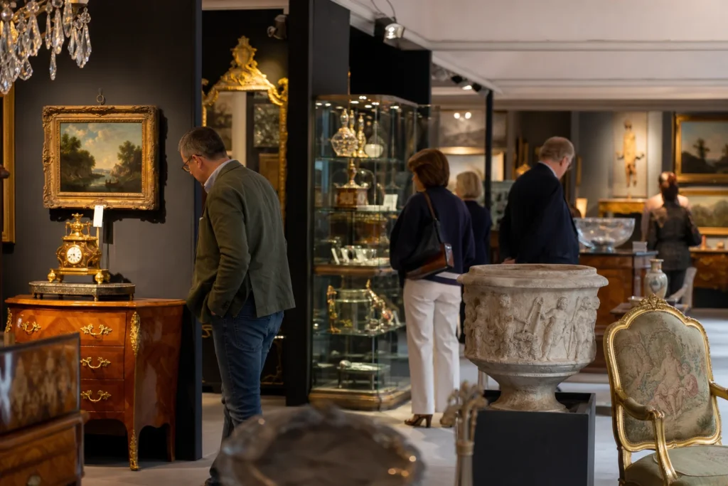 shoppers browsing antique and vintage market stalls at LAPADA Art & Antiques Fair in London