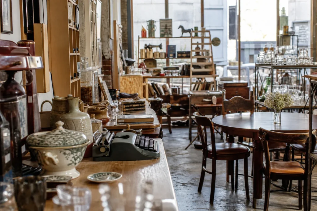 shoppers browsing antique and vintage market stalls at Le Grenier in France